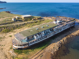 Sudak, Crimea, Russia - July 10, 2021: abandoned steamer stranded, rusty old cruise steamer, ship...