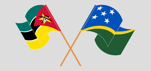 Crossed and waving flags of Mozambique and Solomon Islands