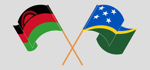 Crossed and waving flags of Malawi and Solomon Islands