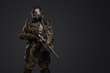 Portrait of soldier survived after atomic catastrophe with gas mask and shotgun.
