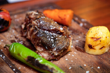 Grilled steak on a wooden plate