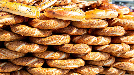 Stack of simit (circular bread) at sunny day. Simit is a popular street food among tourists and residents in Turkey. Closeup view