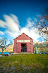 Fototapeta na wymiar Red house of Glenorchy in the blue sky, South Island, New Zealand.