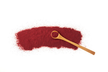 Scattered Beetroot powder pile and wooden spoon on white background. Food additive E162, natural...