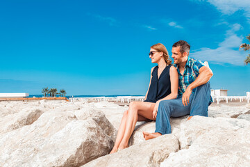 Fototapeta na wymiar Young Couple in Love on the Beach or Resort