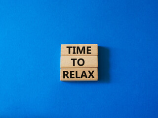Time to relax symbol. Concept word Time to relax on wooden blocks. Beautiful blue background. Business and Time to relax concept. Copy space