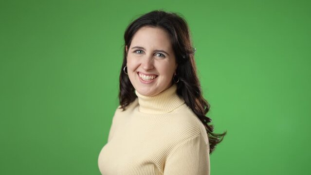 Back rear view smiling happy satisfied young woman 20s turn around to camera showing thumbs up like gesture isolated on green screen background studio portrait. People lifestyle concept