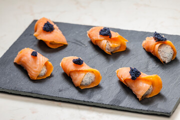 smoked salmon rolls filled with cream cheese and black caviar