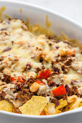 nachos with minced beef , red pepper and beans