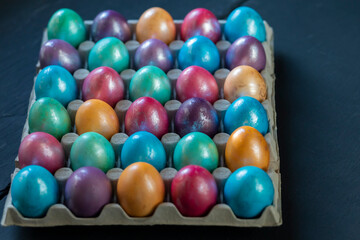 Easter background with hand painted purple, blue, green, orange