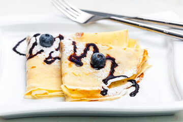 pancakes with blueberries and chocolate sauce