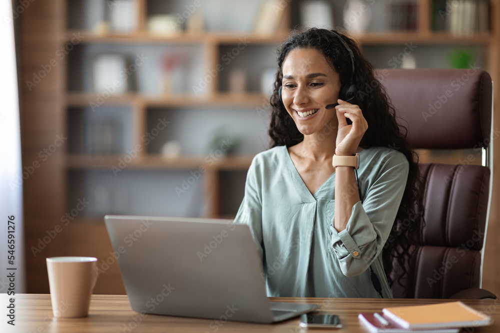 Wall mural happy friendly woman holding video call with clients at office