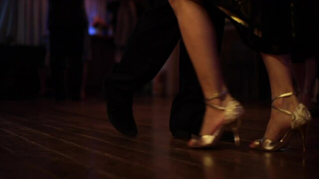 foot steps in the floor of a milonga dancing Argentine Tango in a moody bar cafe
