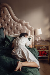 Woman wearing genuine vintage victorian one piece bloomers in retro style bedroom, slight opening on back