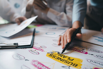 Meeting of hardworking businesspeople work together as a team by presenting graphs. and charting the work of each department, presenting and discussing the report together in the meeting.