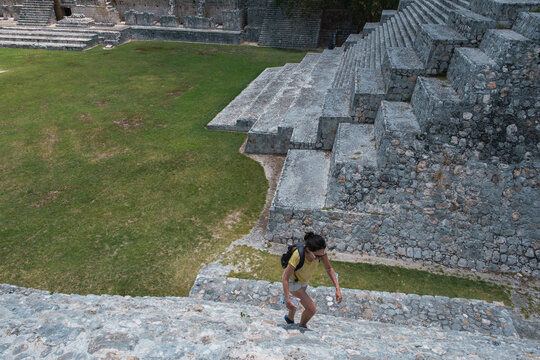 Girl Climbing A Maya Pyramid At Edzna Yucatan Mexico