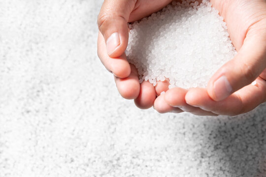 engineer hold white plastic on hand polymer petrochemical product as polymer raw material for plastic in polymer chemical industry design and test in polymer science laboratory