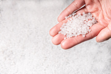 engineer hold white plastic on hand polymer petrochemical product as polymer raw material for...