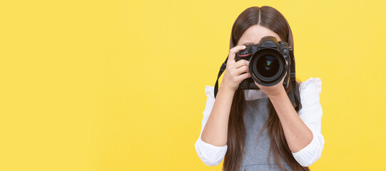 happy teen girl photographer taking picture with digital photo camera, copy space, photographing. Child photographer with camera, horizontal poster, banner with copy space.