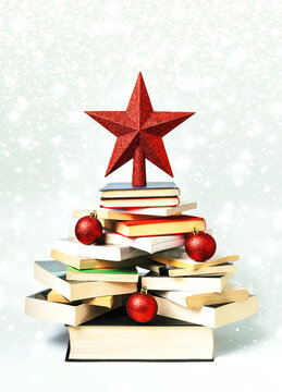 Christmas concept background. Books in the form of a christmas tree with christmas balls and red star