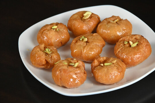 Badusha or Balushahi is a traditional Indian sweet served during festivals and celebrations arranged in a plate.  Diwali sweets.