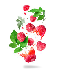 Whole and sliced raspberries with juice splashes in the air isolated on a white background