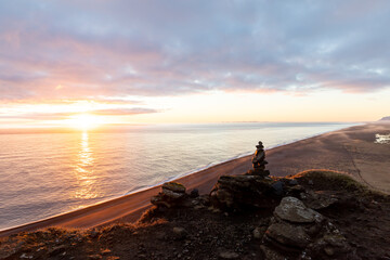 Stacked rocks at the beach during sunset