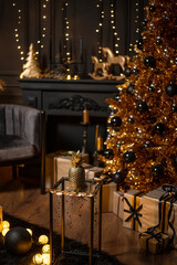 Merry Christmas and Happy Holidays!Beautiful black modern living room decorated for Christmas.Chrystmas Luxury black style living room interior with sofa decorated chic , golden style.Selective focus.