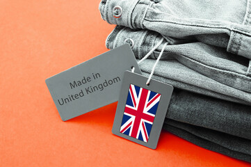 Detail of blue jeans, white label and Made in United Kingdom lettering.