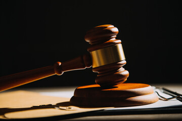 Justice and law concept.Male judge in a courtroom with the gavel, working with, computer and...