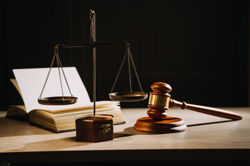 Justice and law concept.Male judge in a courtroom with the gavel, working with, computer and docking keyboard, eyeglasses, on table in morning light