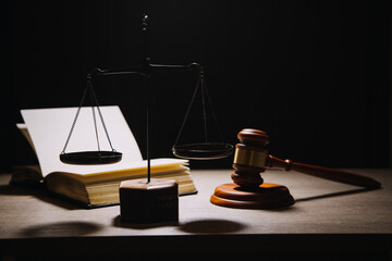 Justice and law concept.Male judge in a courtroom with the gavel, working with, computer and...