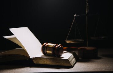 Justice and law concept.Male judge in a courtroom with the gavel, working with, computer and...