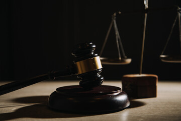Justice and law concept.Male judge in a courtroom with the gavel, working with, computer and...