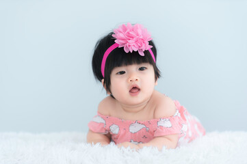 Portrait of cute asian baby on white carpet,Newborn smile for take a photo