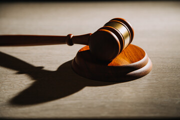 Justice and law concept.Male judge in a courtroom with the gavel, working with, computer and...