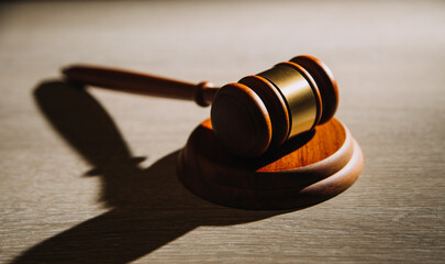 Justice and law concept.Male judge in a courtroom with the gavel, working with, computer and...