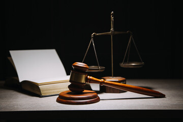 Justice and law concept.Male judge in a courtroom with the gavel, working with, computer and...