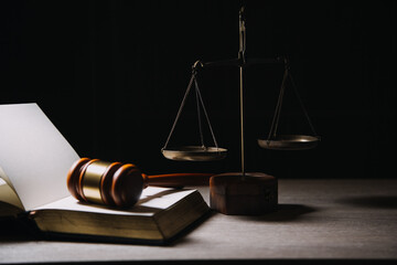 Justice and law concept.Male judge in a courtroom with the gavel, working with, computer and...