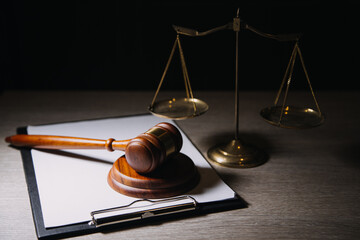 Justice and law concept.Male judge in a courtroom with the gavel, working with, computer and...