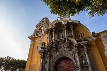 Beautiful sculptures adorn the main entrance of the cathedral in the plaza of a Lima neighborhood.