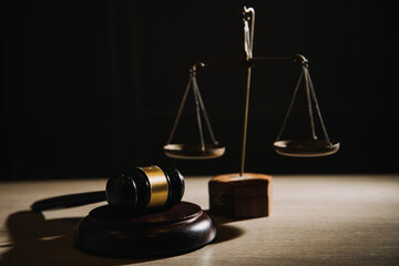 Justice and law concept.Male judge in a courtroom with the gavel, working with, computer and...