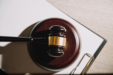 Justice and law concept.Male judge in a courtroom with the gavel, working with, computer and...