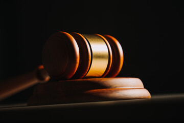 Justice and law concept.Male judge in a courtroom with the gavel, working with, computer and...