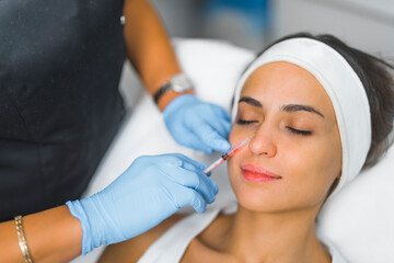 closeup view of a Latin girl having mesotherapy procedure at the spa, cosmetic procedure concept. High quality photo