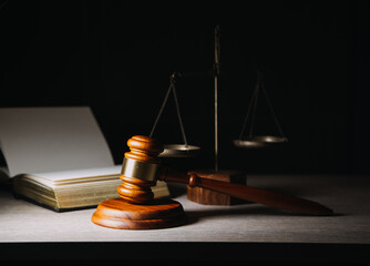 Justice and law concept.Male judge in a courtroom with the gavel, working with, computer and...