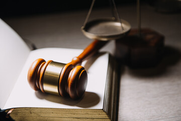 Justice and law concept.Male judge in a courtroom with the gavel, working with, computer and...