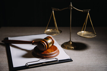 Justice and law concept.Male judge in a courtroom with the gavel, working with, computer and...