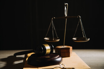 Justice and law concept.Male judge in a courtroom with the gavel, working with, computer and...