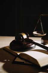 Justice and law concept.Male judge in a courtroom with the gavel, working with, computer and docking keyboard, eyeglasses, on table in morning light